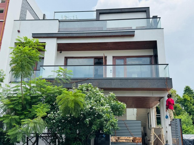 HPL and ACP elevation cladding on beam cover, ceiling and balcony in a modern house design